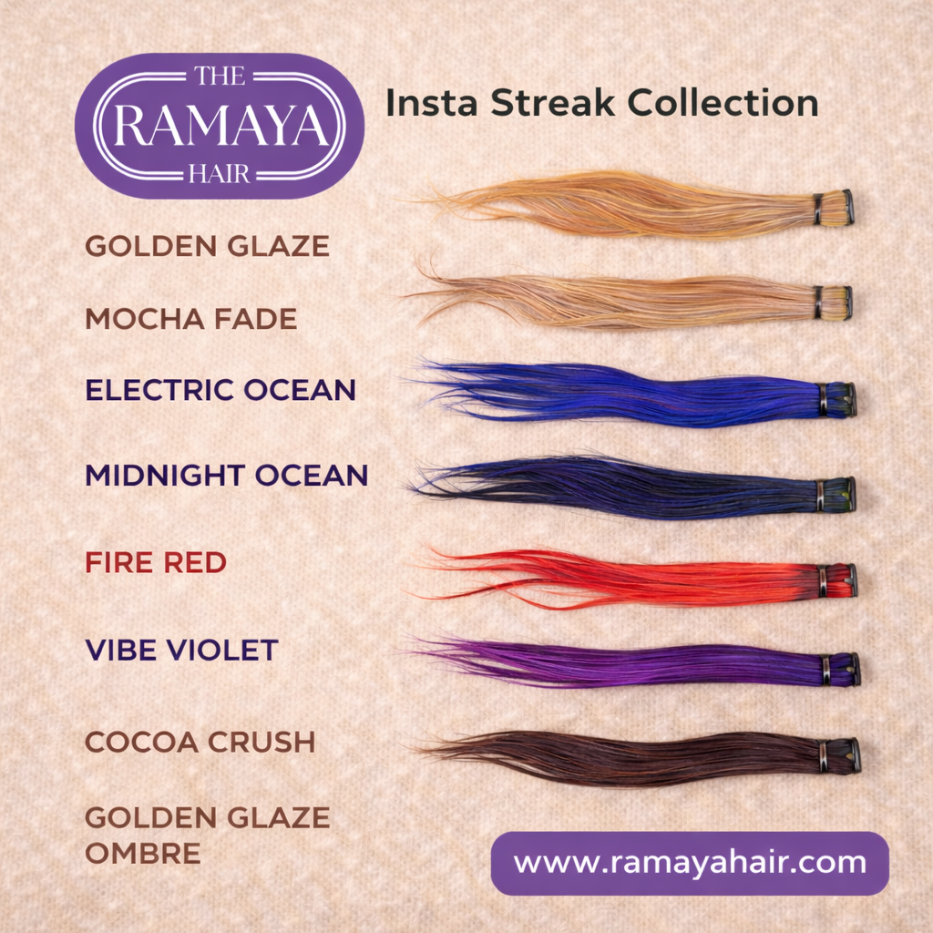 Smiling woman with dark hair and blue hair extension, wearing white top and jeans, with Buddha statue in background